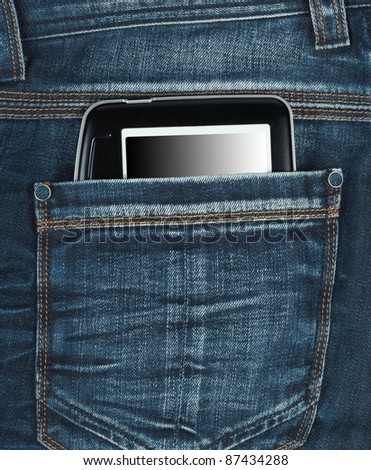e-book in the back pocket of blue jeans