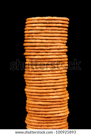 The high pile of delicious salty crackers isolated on a black background