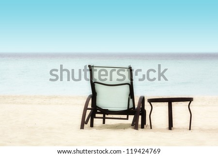 Empty Chair and Table on a Tropical Beach