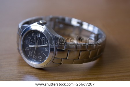 Ladies stainless steel watch on a wood table