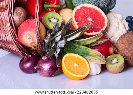 Many fresh colorful fruits and vegetables in basket