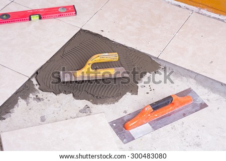 Notched trowel, spacers and prepared setting compound for tile