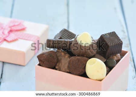 Delicious chocolate candies in gift box on table close-up