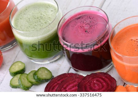 Vegetable juice (carrot, beet, cucumber, tomato). Isolated on white background