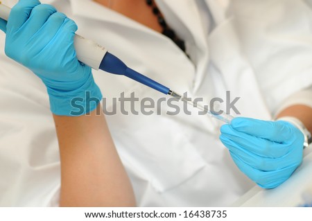 Working in laboratory. Protected with lab coat and gloves.