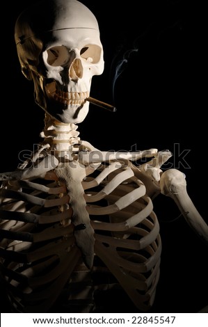 Human skeleton is smoking a cigar. Smoking is not good for your health.