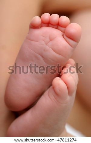 New born baby feet from below.