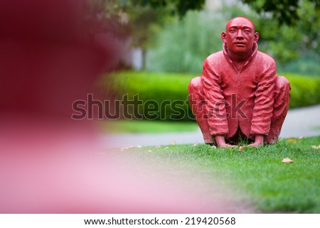 statue of squatting buddhist monks, public sculpture titled \'Meeting\' by Wang Shugang, Cardero Park, Vancouver, British Columbia