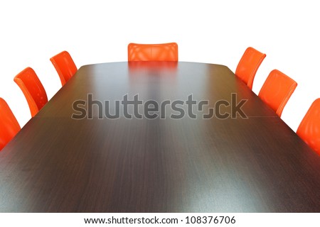 Meeting room with brown table , orange armchairs and wood wall. Office interior