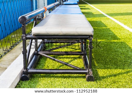Benches in indoor football field for cheering team