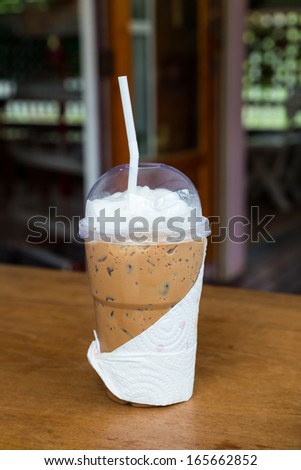 Take home cup of ice coffee on table