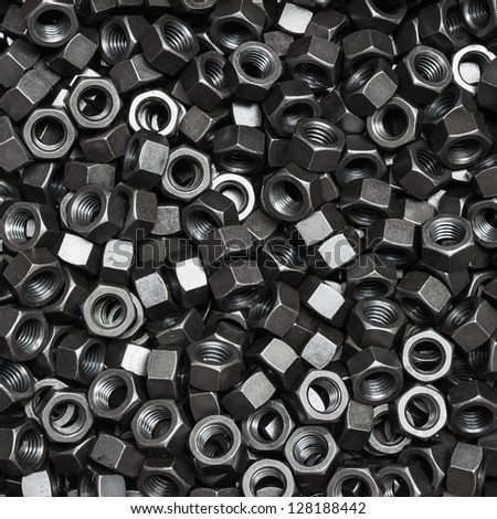 Pile of black oxide and oil plating nuts, a shop floor item, square cropped