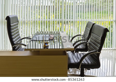 Chief executive or manager office with desk and armchairs, office interior