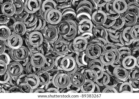 Close up of pile of stainless steel spring washers, a shop floor item