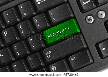 Close up of black pc keyboard, focus on green contact us key, internet concept