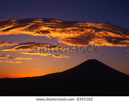 Giant orange clouds hanging over Mount Fuji