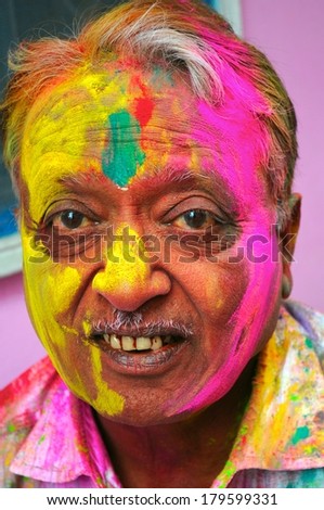 Portrait of an old Indian male during Holi festival.