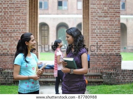 Two Indian college girls talking to each other.