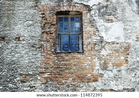 Lonely window on the brick wall of an old building