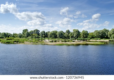 Beautiful rural landscape - scenic river against the sky with clouds