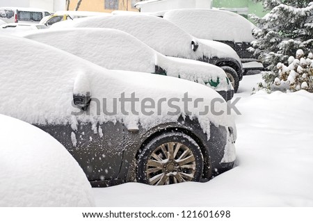 Cityscape - parked cars covered with snow