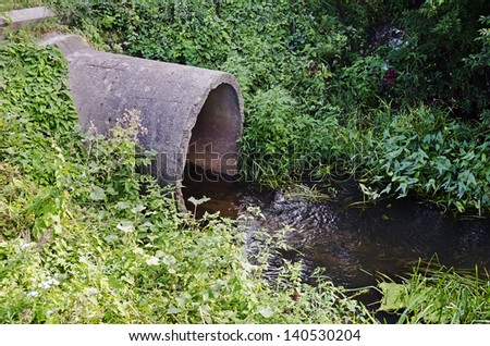 Concrete spillway - concrete pipe from which the water flows