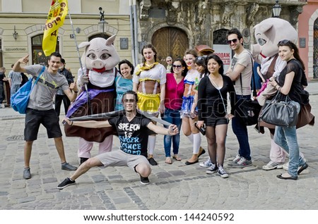 LVOV, UKRAINE - APRIL 27: Tourists are photographed with fairy tale characters in the heart of the city on the day of celebration of the city on April 27, 2013 in Lviv, Ukraine