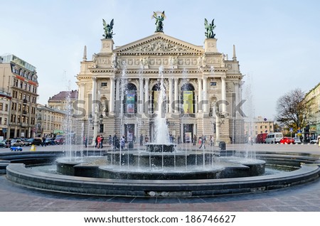 Lvov, Ukraine - OCTOBER 11, 2013: Fountain and the people on the square in front of the Opera House in the center of Lvov on October 11, 2013 in Lvov, Ukraine