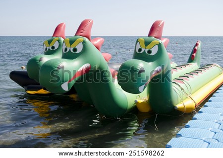 SUDAK, CRIMEA, RUSSIA - AUGUST 24: Attraction on the water in the form of a three-headed dragon on the seafront in the resort town of Sudak on August 24, 2014 in Sudak, Crimea, Russia