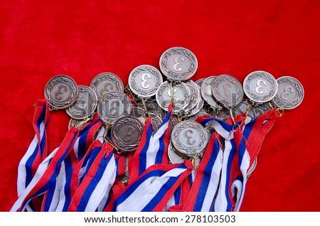 Many bronze medals with tricolor ribbons close-up. Medal for third place in the competition