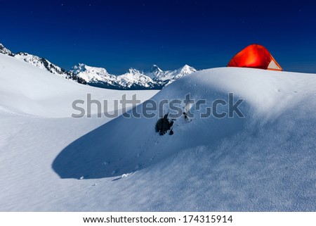 Glowing Tent under Moonlight on Snow Mountain