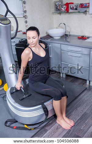 beautiful woman on trainer machine in sport gym