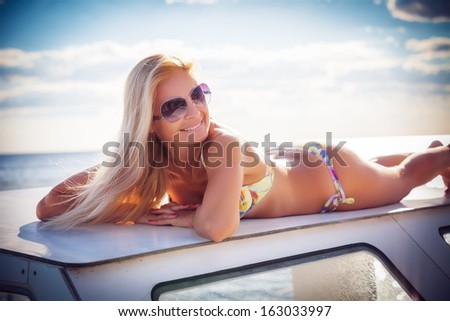 young beautiful girl by the boat