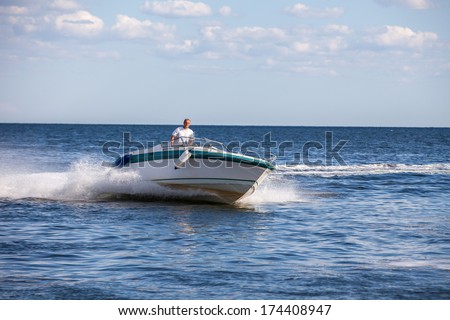 Man driving a fast boat