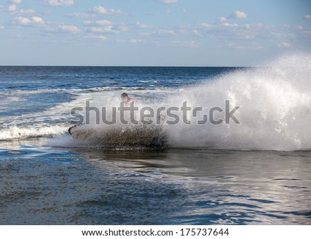 strong man drive on the jetski above the water