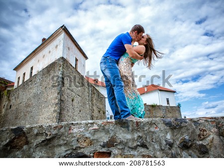 guy kissing the girlfriend against the old lock
