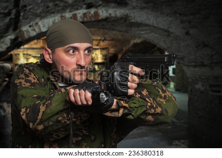 Portrait of the soldier with the gun in hands