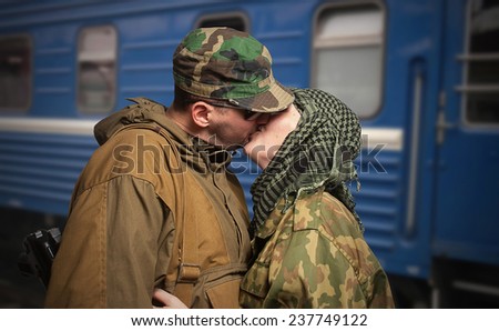 Romantic scene of farewell of wife with husband leaving on military service