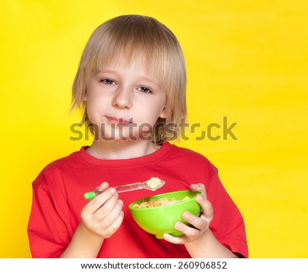 Blond boy kid child eating corn flakes cereal