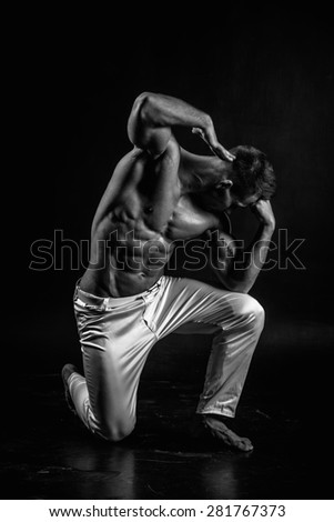 very muscular handsome athletic man on black background
