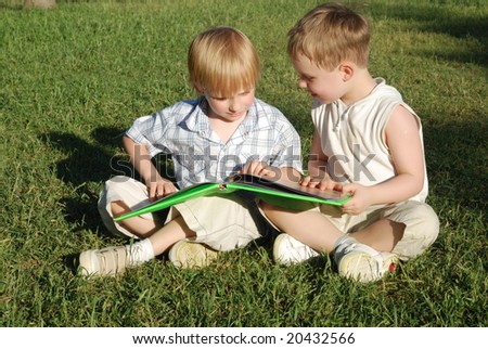 Two brothers with the book in park