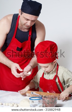 The father with the son work up dough. A transfer of experience .