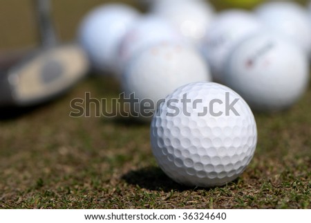 A golf ball and driver with focus on the ball