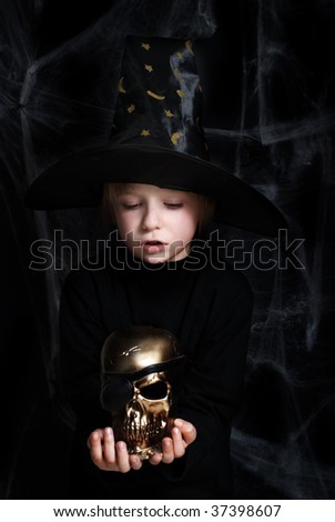 The small magician with a gold skull of dead pirate