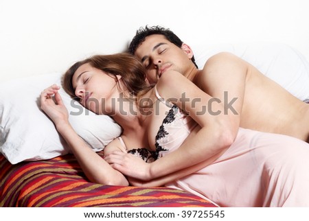 Young couple sleeping together in bed.