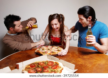 The cheerful company of youth eating a pizza