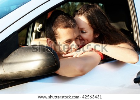 Happy young pair in just bought car.Vacation