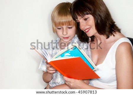 Mother with the son reading the book