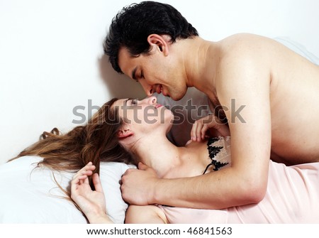 Young attractive happy couple in bedroom