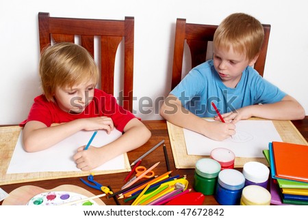 The boys of school return drawing on a paper clean sheet